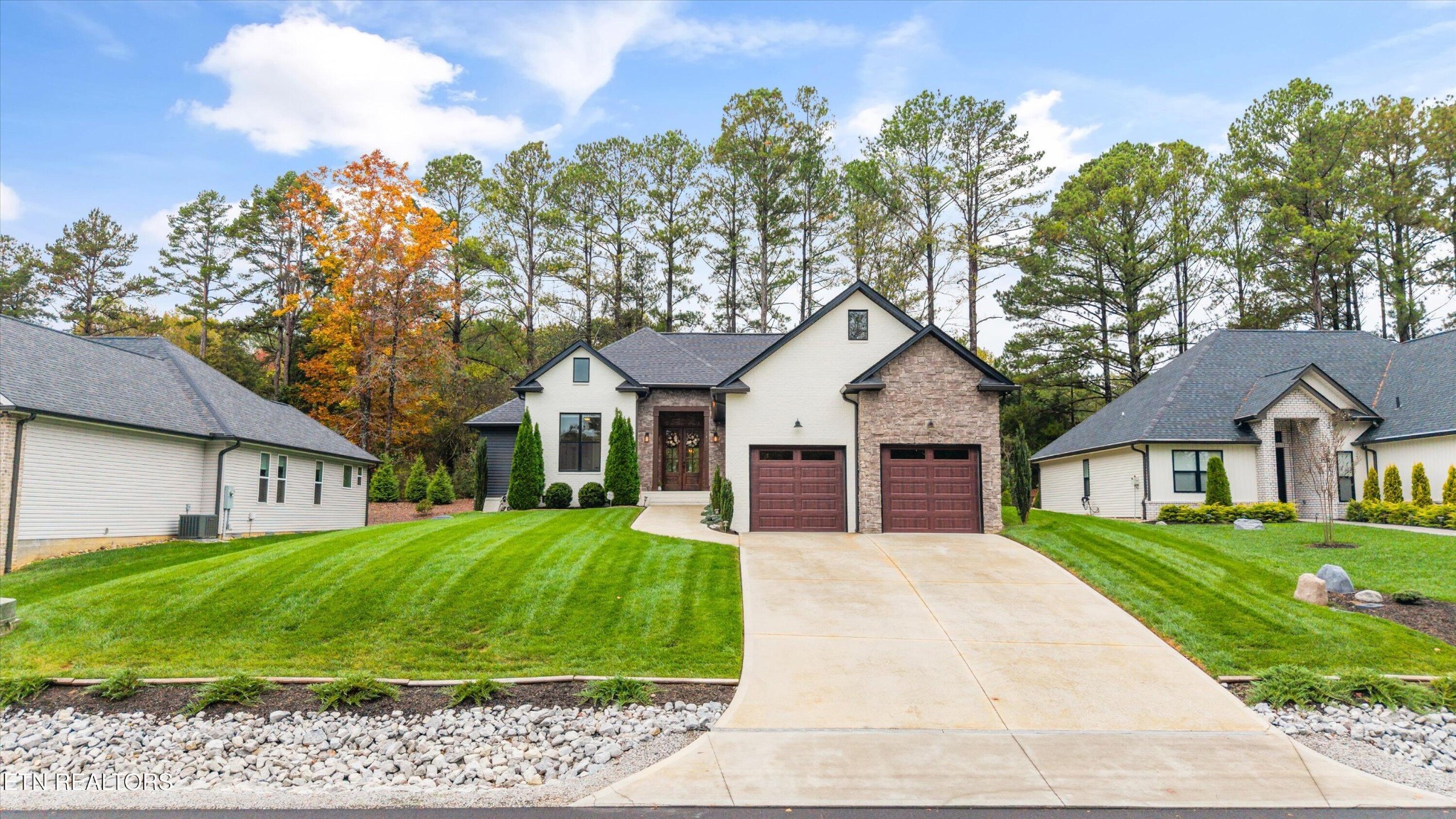 364 Mingo Way Loudon, TN 37774 - Photo 2 of 55 a view of a white house next to a yard with big trees