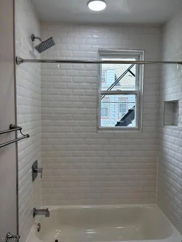 a bathroom with a bathtub and shower