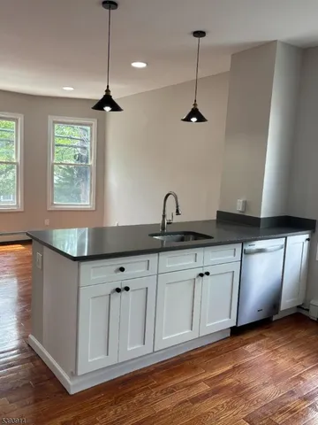 a kitchen with granite countertop a sink and cabinets