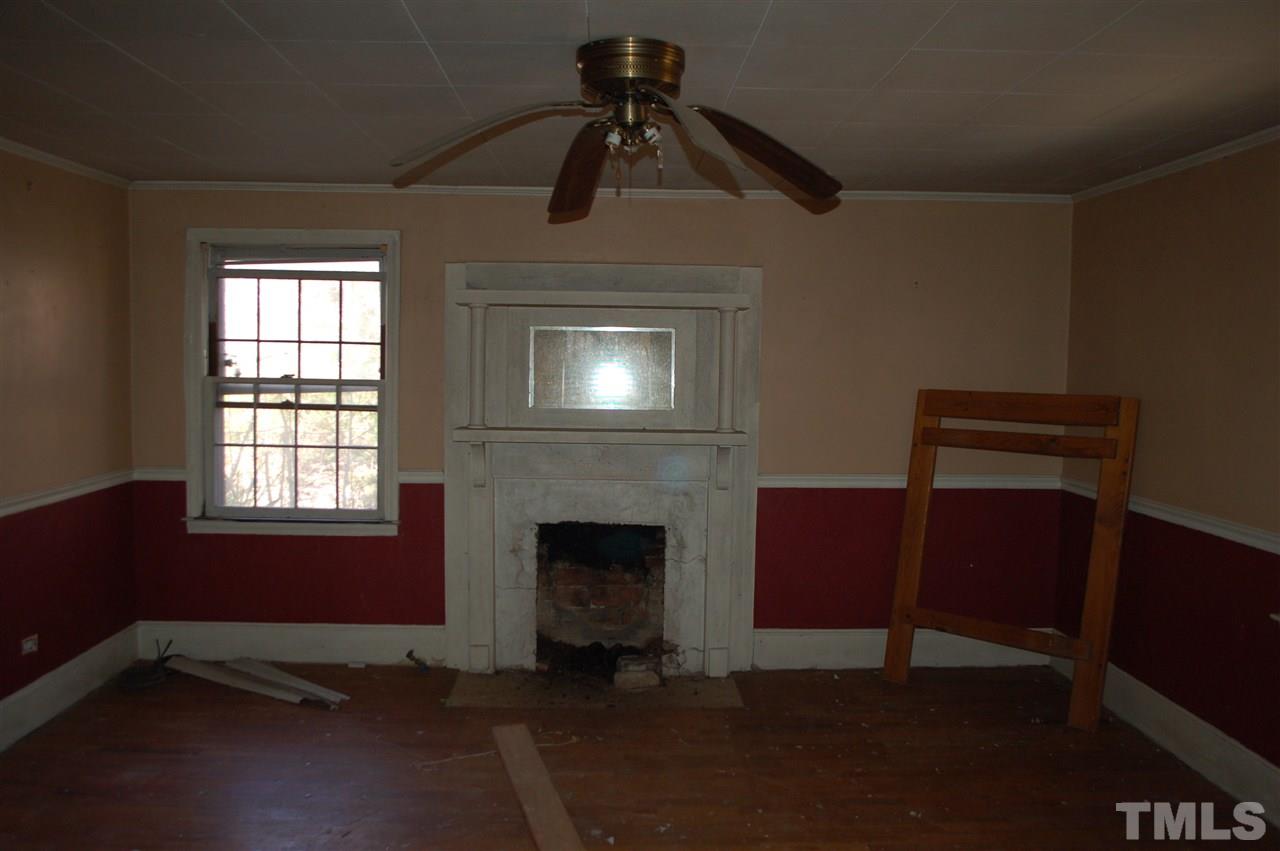 820 Billy Hicks Road Roxboro, NC 27574 - Photo 22 of 27 a living room with furniture and a fireplace