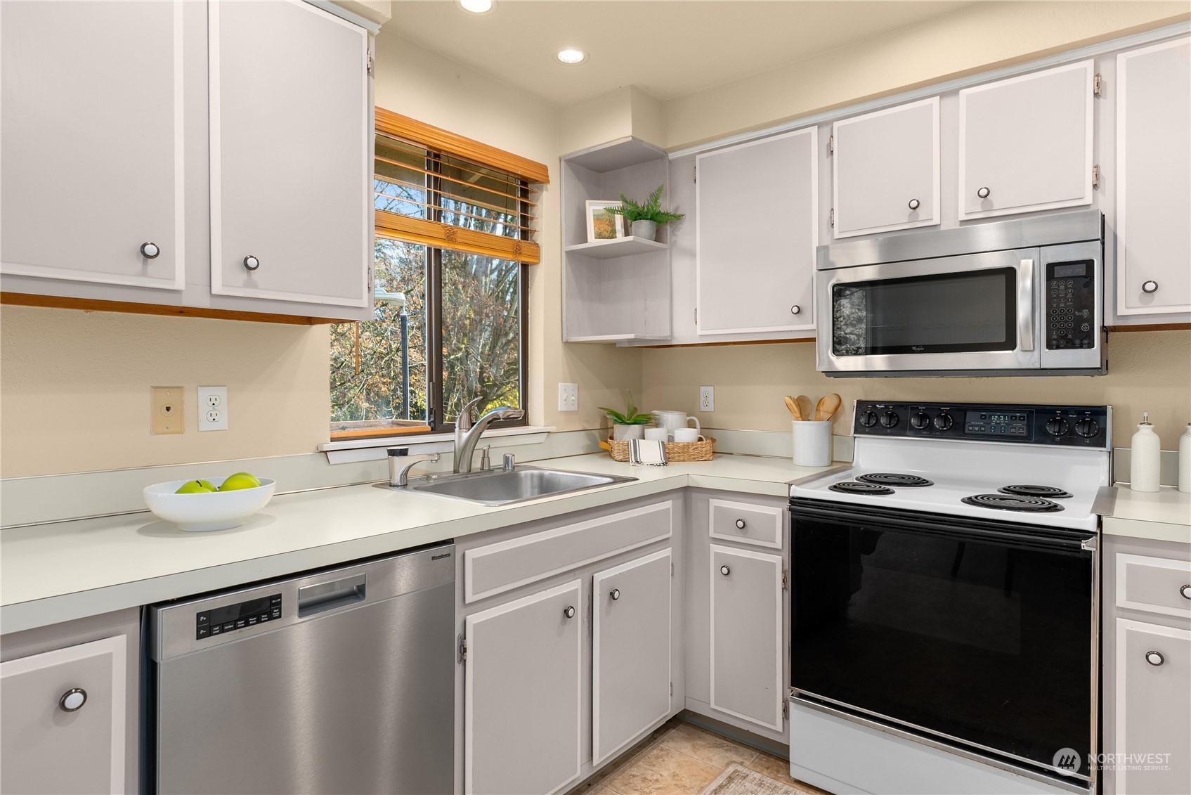 113 239th Place Southwest Bothell, WA 98021 - Photo 10 of 31 a kitchen with a sink stove and microwave
