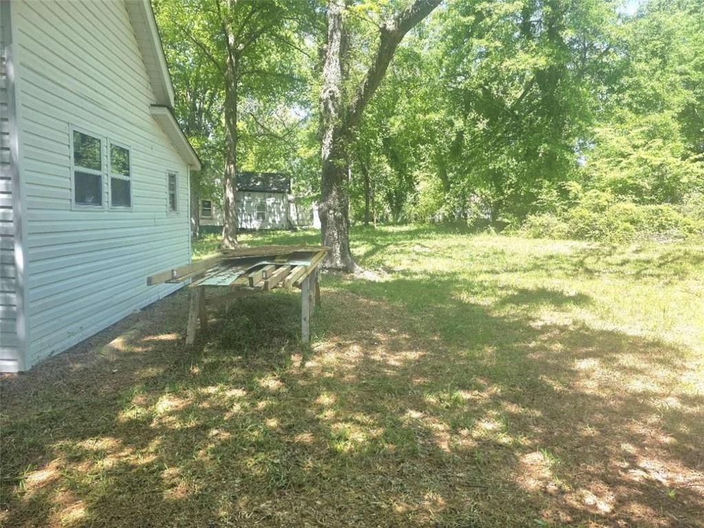 108 G Avenue Thomaston, GA 30286 - Photo 18 of 19 a view of a yard with plants and large trees