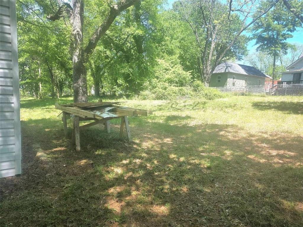 108 G Avenue Thomaston, GA 30286 - Photo 19 of 19 a backyard of a house with lots of green space