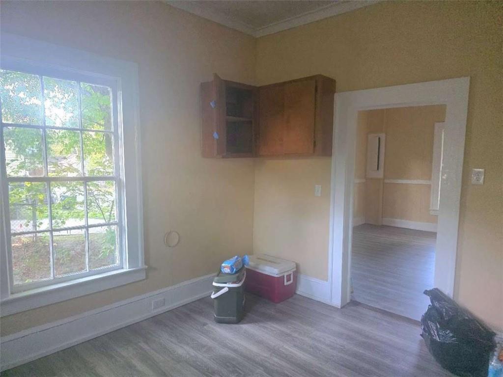108 G Avenue Thomaston, GA 30286 - Photo 4 of 19 a view of an empty room with wooden floor and a window