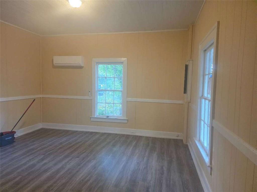 108 G Avenue Thomaston, GA 30286 - Photo 7 of 19 an empty room with wooden floor and windows