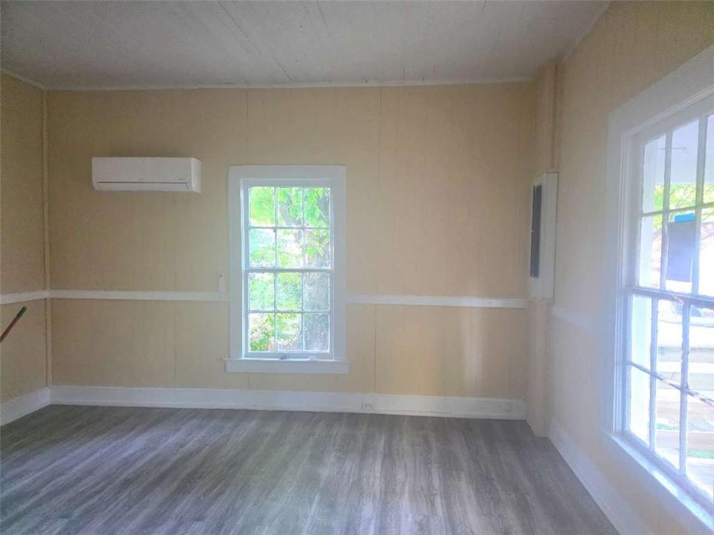 108 G Avenue Thomaston, GA 30286 - Photo 8 of 19 an empty room with wooden floor and windows