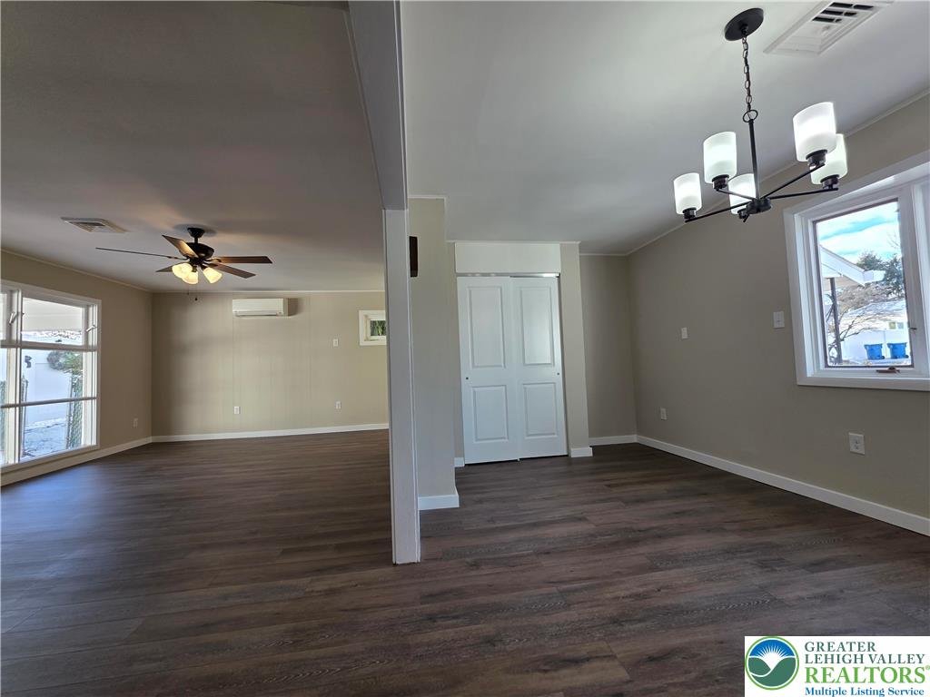 1958 Aripine Avenue Bethlehem, PA 18018 - Photo 11 of 30 an empty room with wooden floor chandelier fan and windows