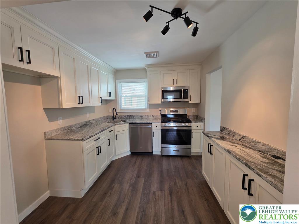 1958 Aripine Avenue Bethlehem, PA 18018 - Photo 12 of 30 a kitchen with granite countertop a sink cabinets stainless steel appliances and a window