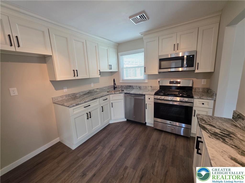 1958 Aripine Avenue Bethlehem, PA 18018 - Photo 13 of 30 a kitchen with stainless steel appliances a white stove top oven and sink