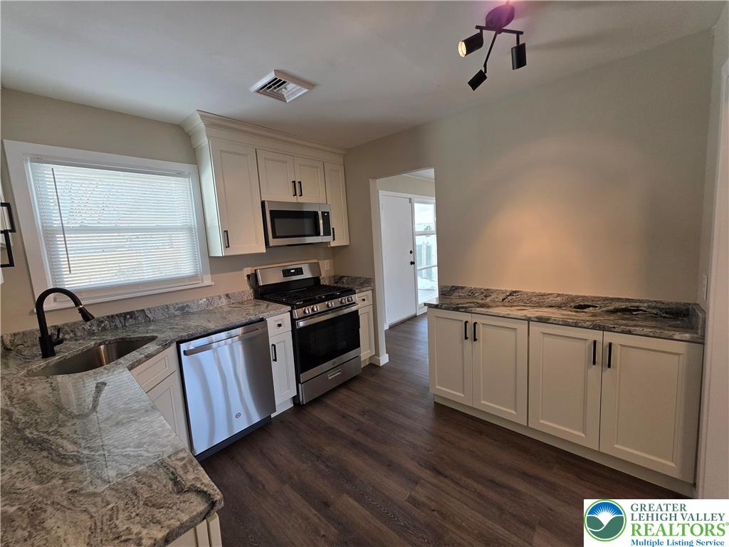 1958 Aripine Avenue Bethlehem, PA 18018 - Photo 14 of 30 a kitchen with granite countertop a stove and a sink