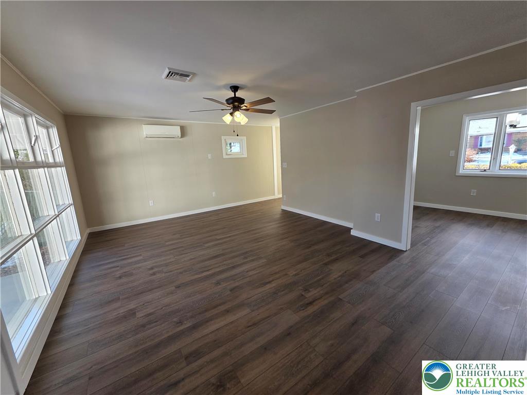1958 Aripine Avenue Bethlehem, PA 18018 - Photo 15 of 30 an empty room with wooden floor chandelier fan and windows