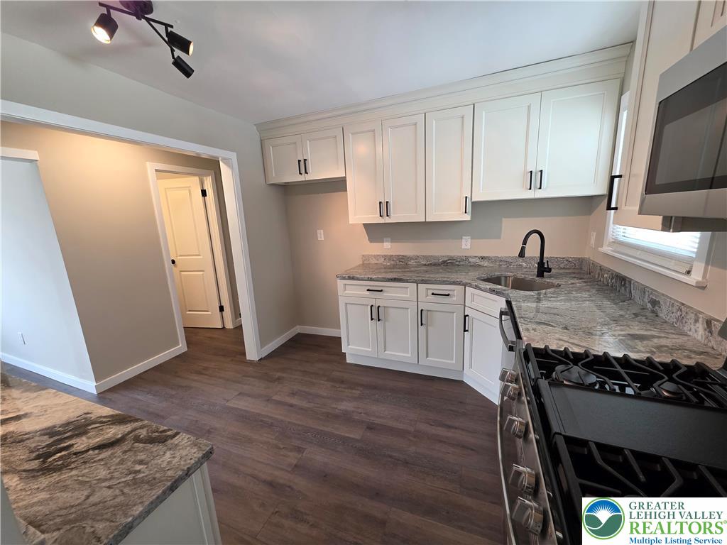 1958 Aripine Avenue Bethlehem, PA 18018 - Photo 16 of 30 a kitchen with granite countertop a sink stove and cabinets