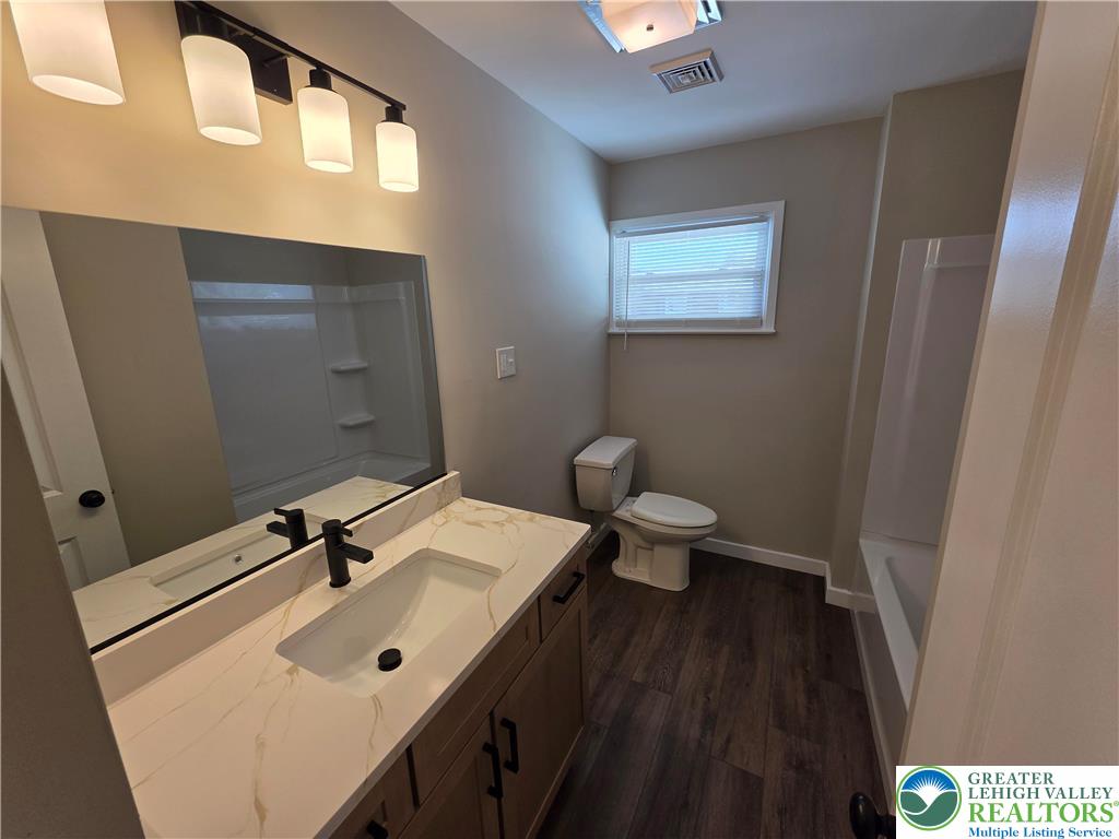 1958 Aripine Avenue Bethlehem, PA 18018 - Photo 17 of 30 a bathroom with a sink a toilet and mirror