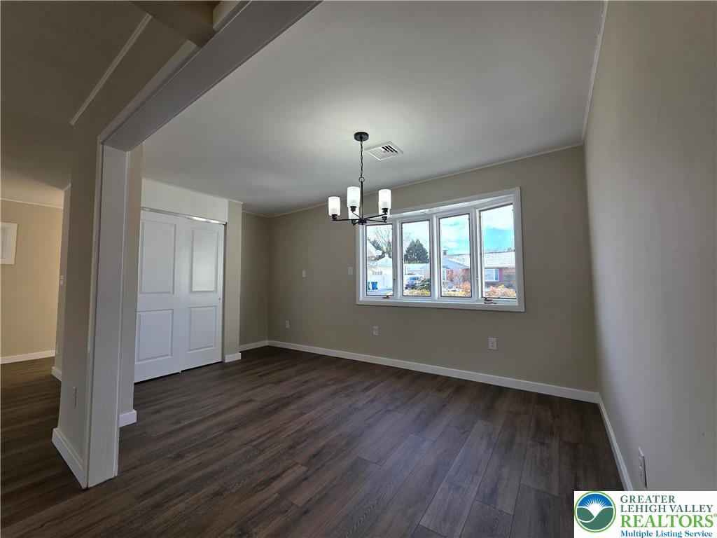 1958 Aripine Avenue Bethlehem, PA 18018 - Photo 9 of 30 an empty room with wooden floor chandelier and windows