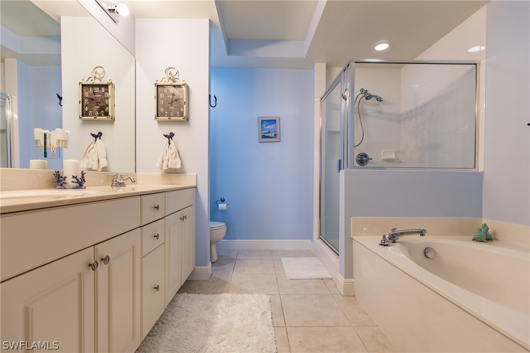 2743 First Street, Unit 704 Fort Myers, FL 33916 - Photo 12 of 17 a bathroom with a tub sink and mirror