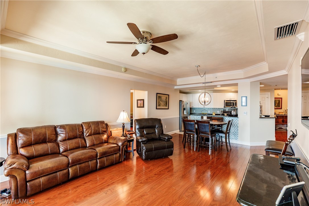 2743 First Street, Unit 704 Fort Myers, FL 33916 - Photo 7 of 17 a living room with furniture and a wooden floor