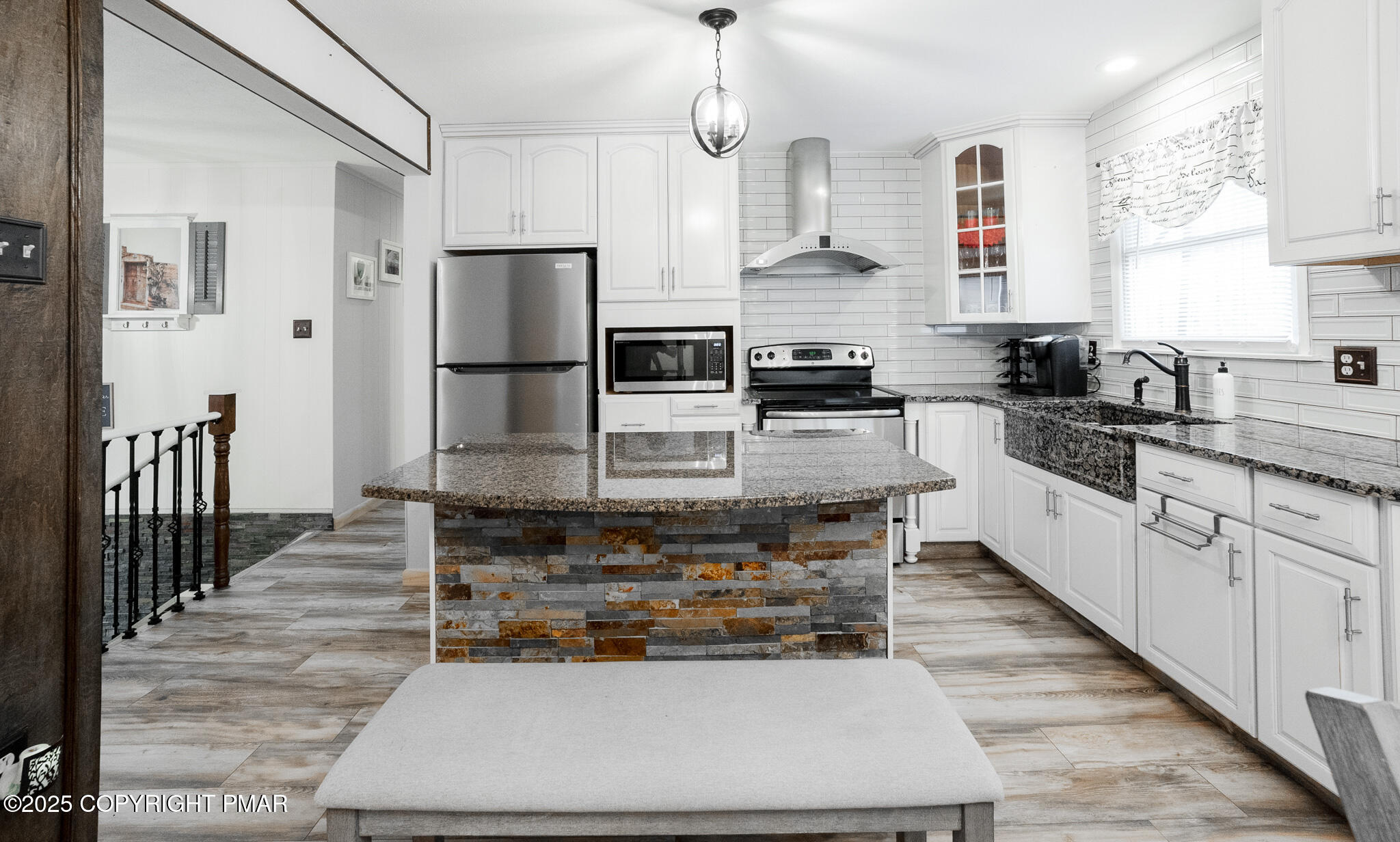 3118 Ogontz Drive Pocono Lake, PA 18347 - Photo 17 of 66 a kitchen with stainless steel appliances kitchen island granite countertop a refrigerator oven a sink dishwasher and white cabinets with wooden floor