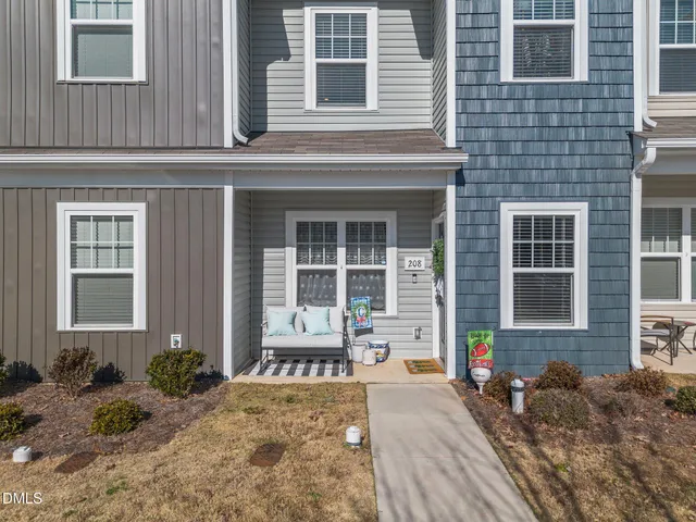 a front view of a house with outdoor seating