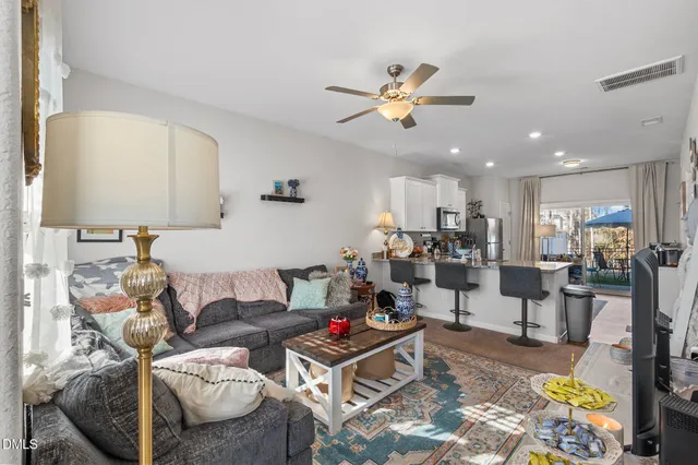 a living room with furniture and a potted plant