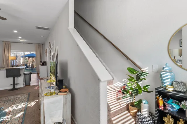 a living room with furniture a chandelier and a window