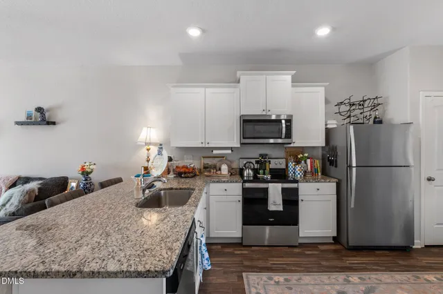 a kitchen with a sink appliances and cabinets