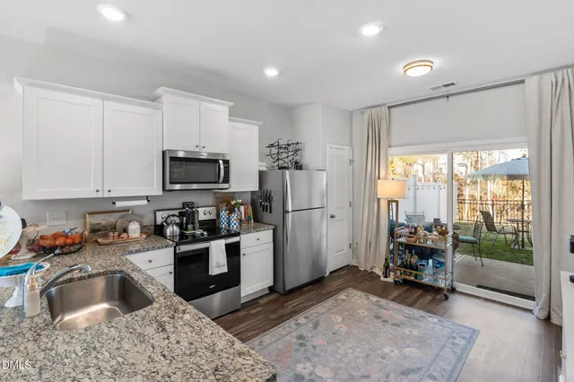 a view of kitchen with furniture and a refrigerator