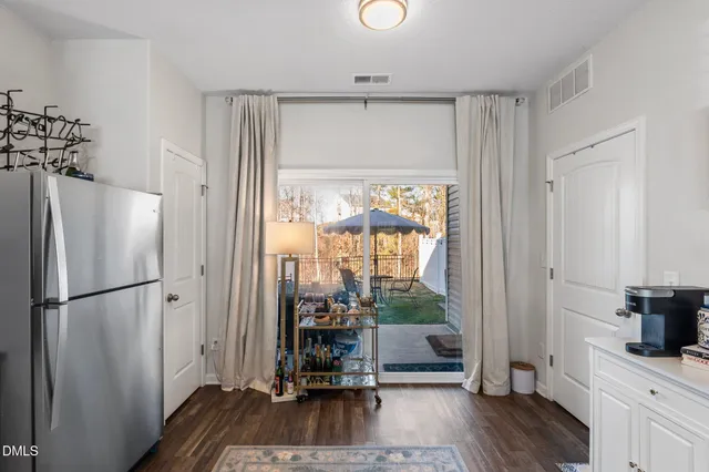 a kitchen with a sink a faucet a chandelier and living room view