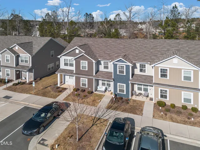 a front view of a residential apartment building with a yard