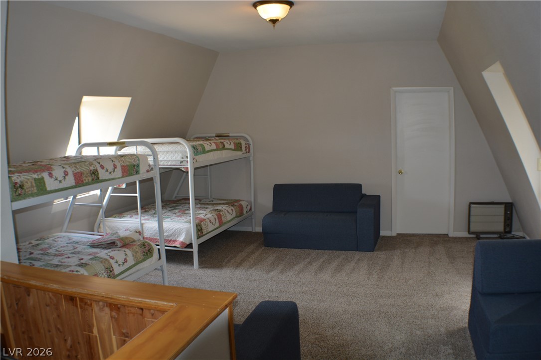 1321 Trout Canyon Road Las Vegas, NV 89124 - Photo 29 of 50 A versatile sleeping area with cozy bunk beds and comfortable seating awaits.