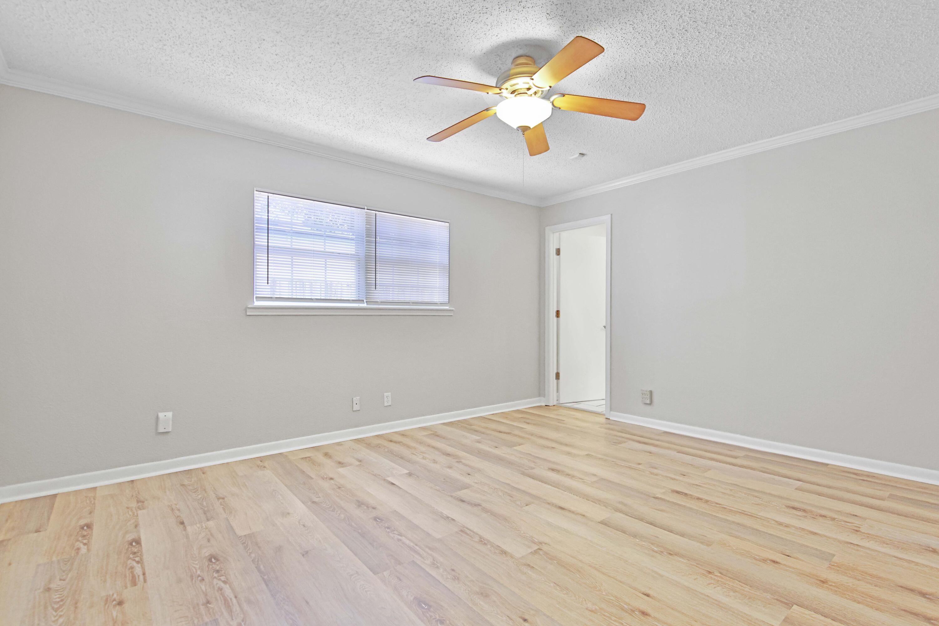 4310 42nd Street Lubbock, TX 79413 - Photo 11 of 30 wooden floor in an empty room with a window