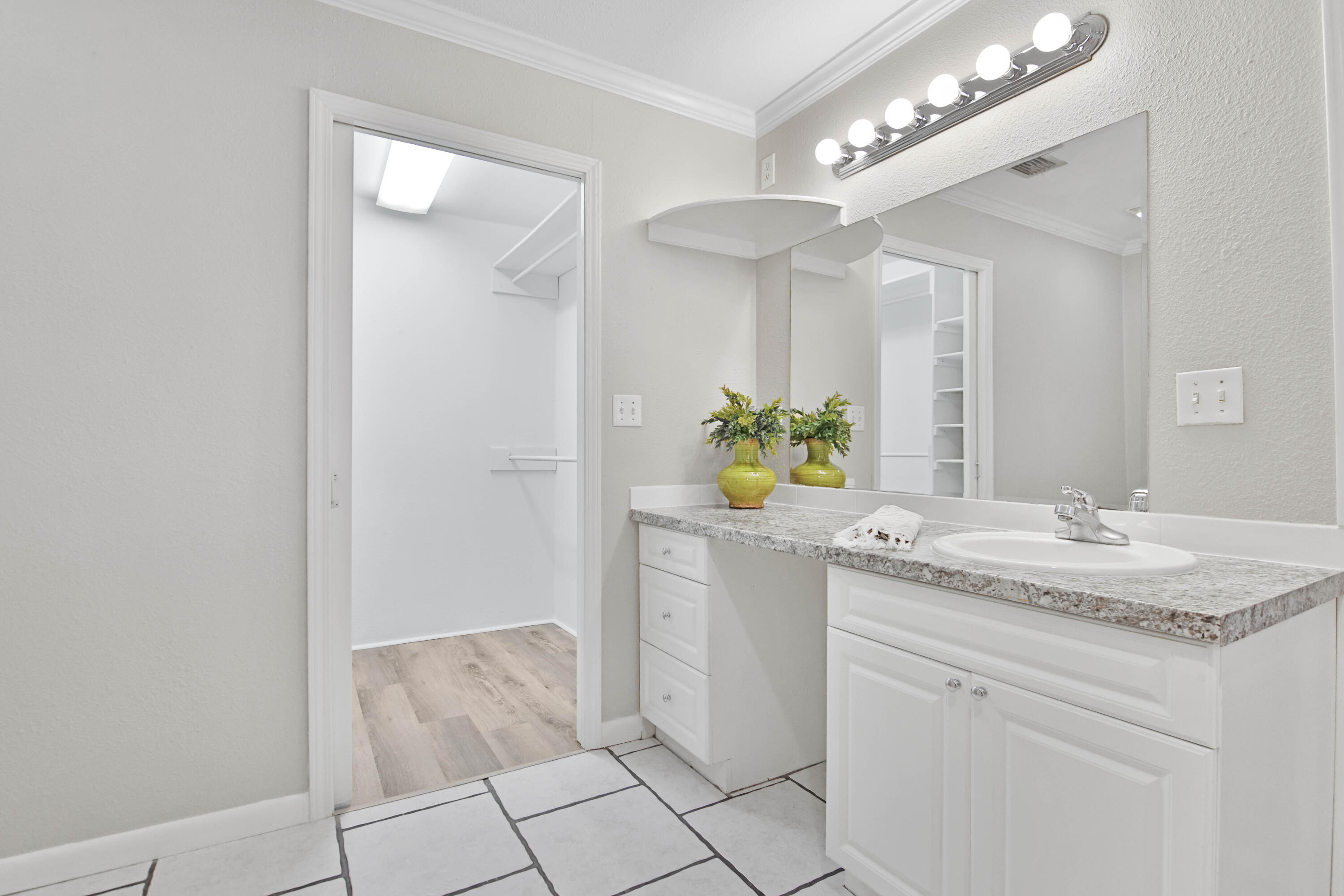 4310 42nd Street Lubbock, TX 79413 - Photo 14 of 30 a bathroom with a granite countertop sink a vanity and a mirror
