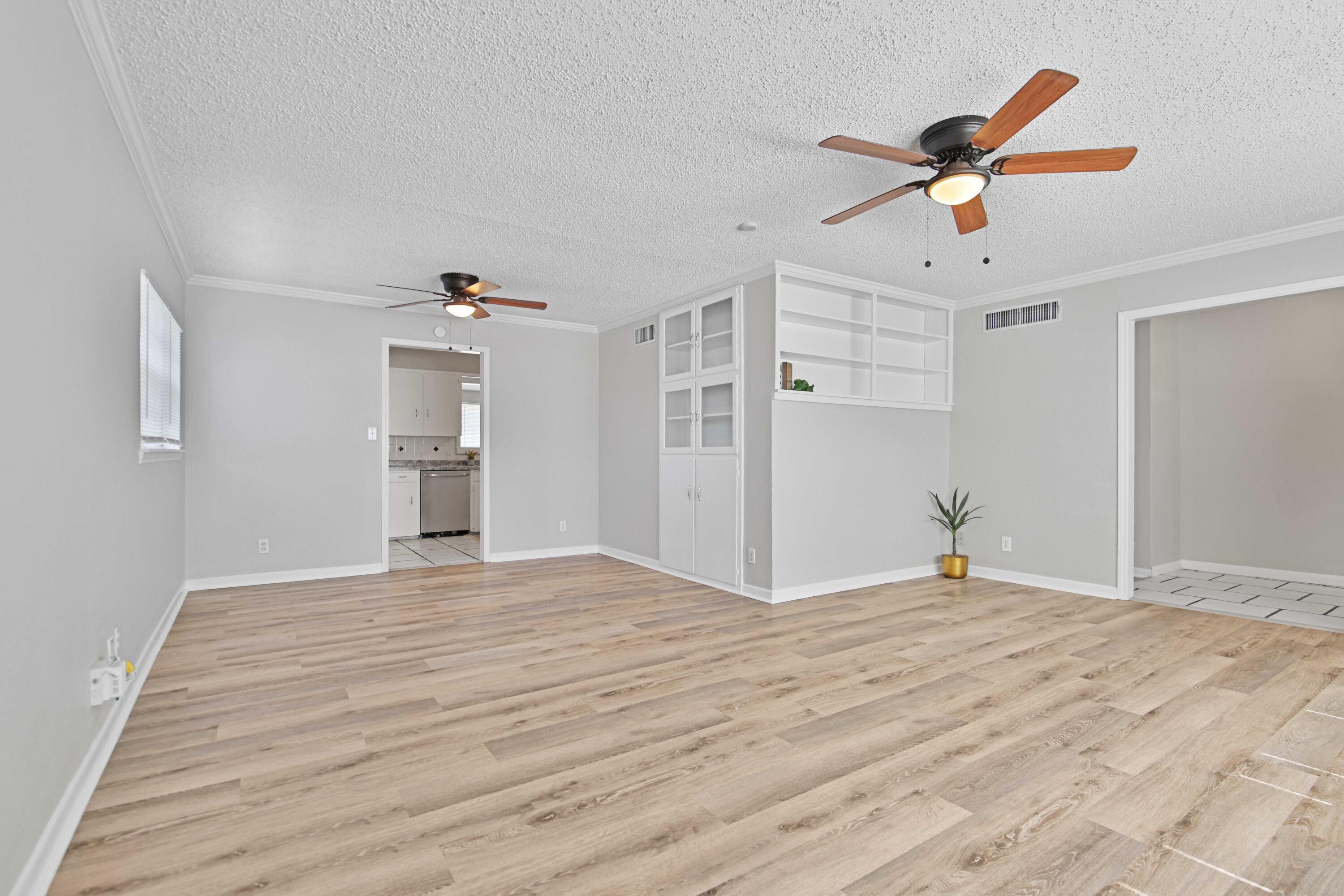 4310 42nd Street Lubbock, TX 79413 - Photo 3 of 30 a view of empty room with wooden floor and ceiling fan