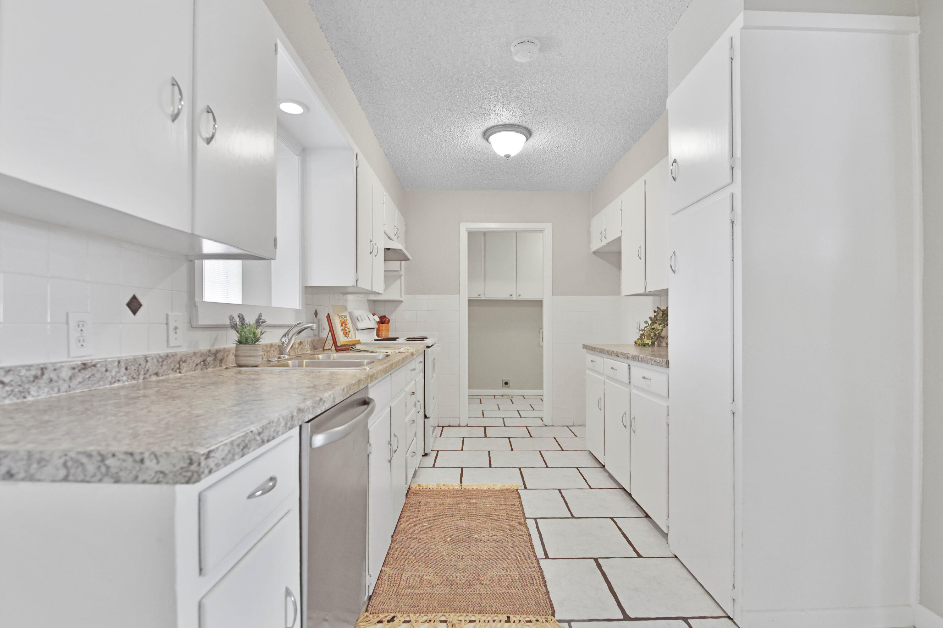 4310 42nd Street Lubbock, TX 79413 - Photo 5 of 30 a kitchen with stainless steel appliances granite countertop a sink and cabinets