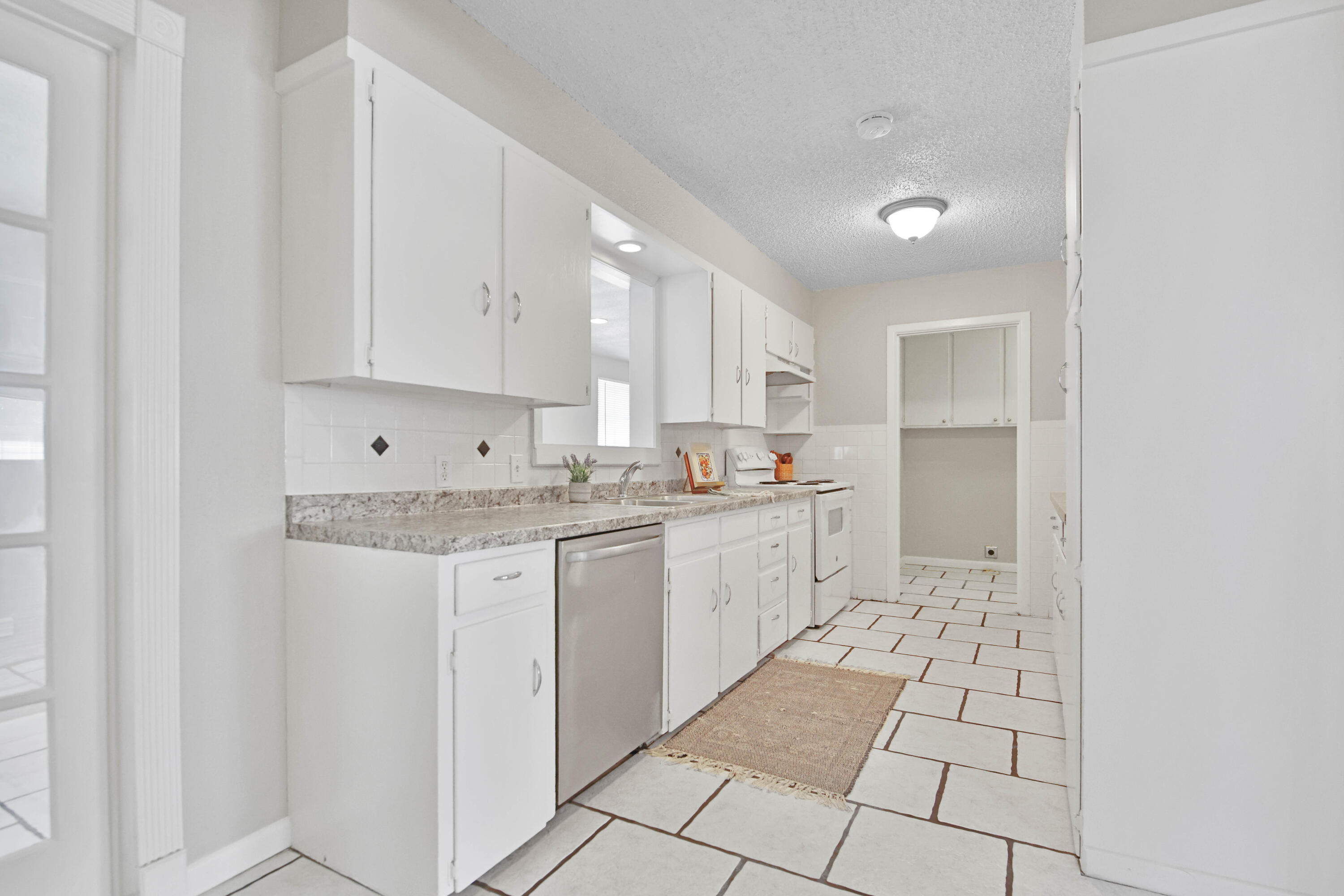 4310 42nd Street Lubbock, TX 79413 - Photo 6 of 30 a kitchen with stainless steel appliances granite countertop a sink and cabinets
