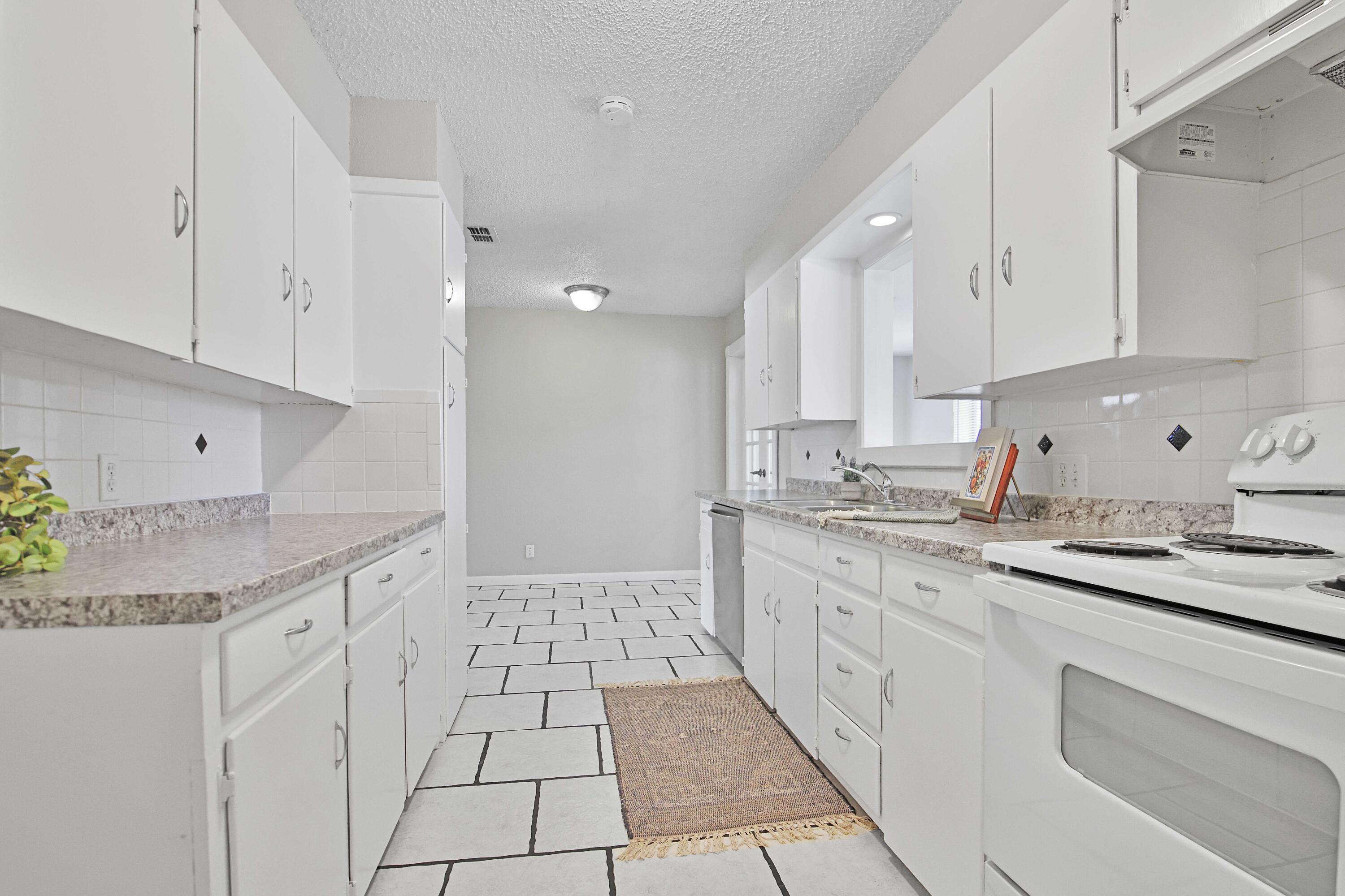 4310 42nd Street Lubbock, TX 79413 - Photo 7 of 30 a kitchen with a sink stove and cabinets