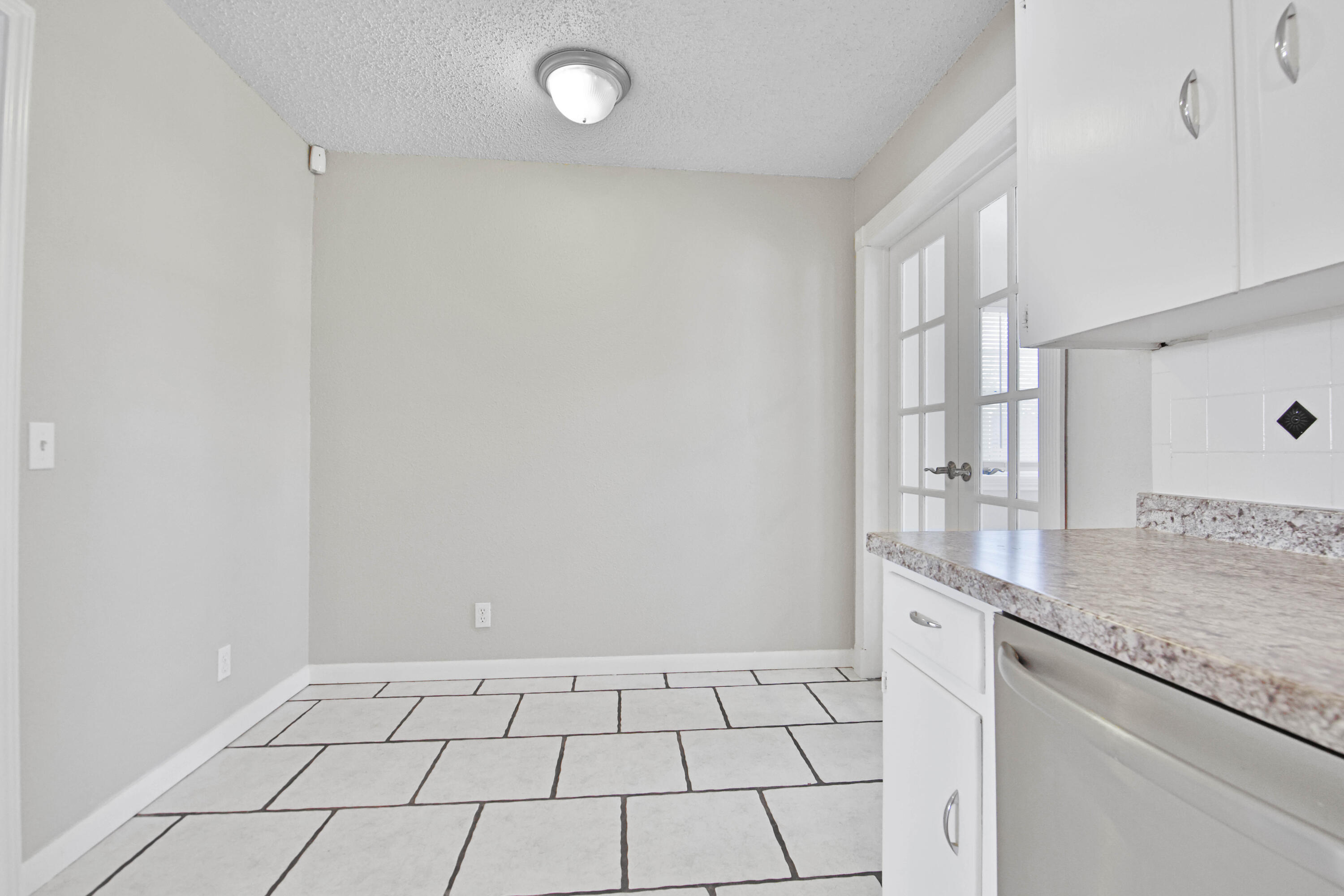 4310 42nd Street Lubbock, TX 79413 - Photo 8 of 30 a view of a kitchen with white cabinets