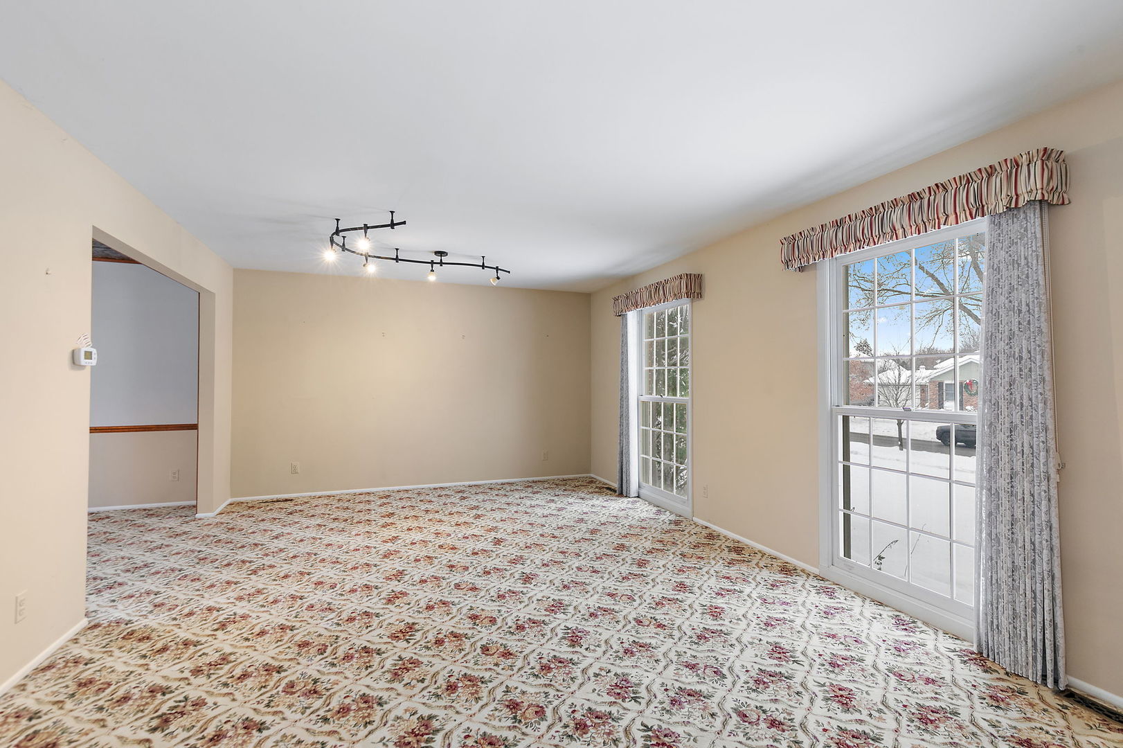 1021 Abbey Drive Crystal Lake, IL 60014 - Photo 3 of 28 a big room with a chandelier fan and windows