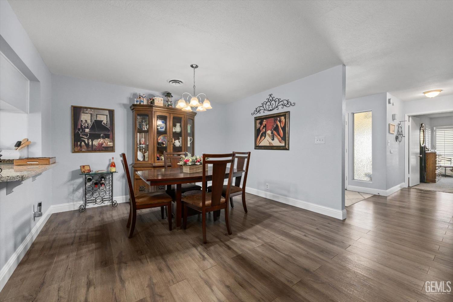 Undisclosed Address Bakersfield, CA 93309 - Photo 14 of 34 a view of a dining room with furniture and wooden floor