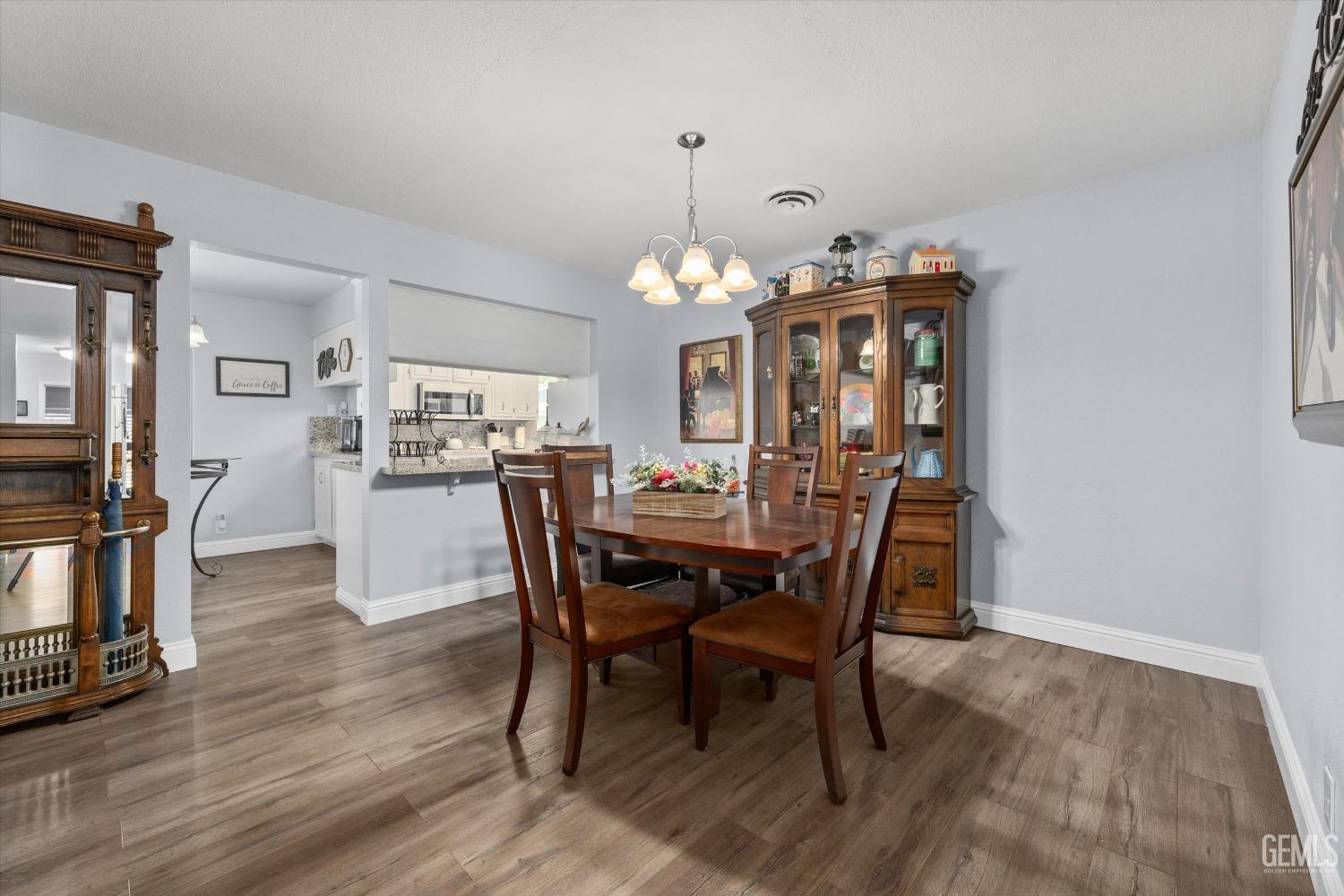 Undisclosed Address Bakersfield, CA 93309 - Photo 15 of 34 a view of a dining room with furniture and wooden floor