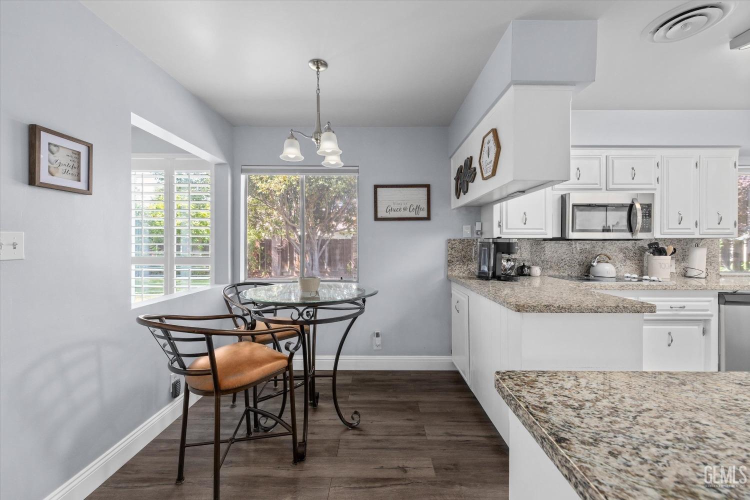 Undisclosed Address Bakersfield, CA 93309 - Photo 16 of 34 a view of kitchen with granite countertop microwave and cabinets
