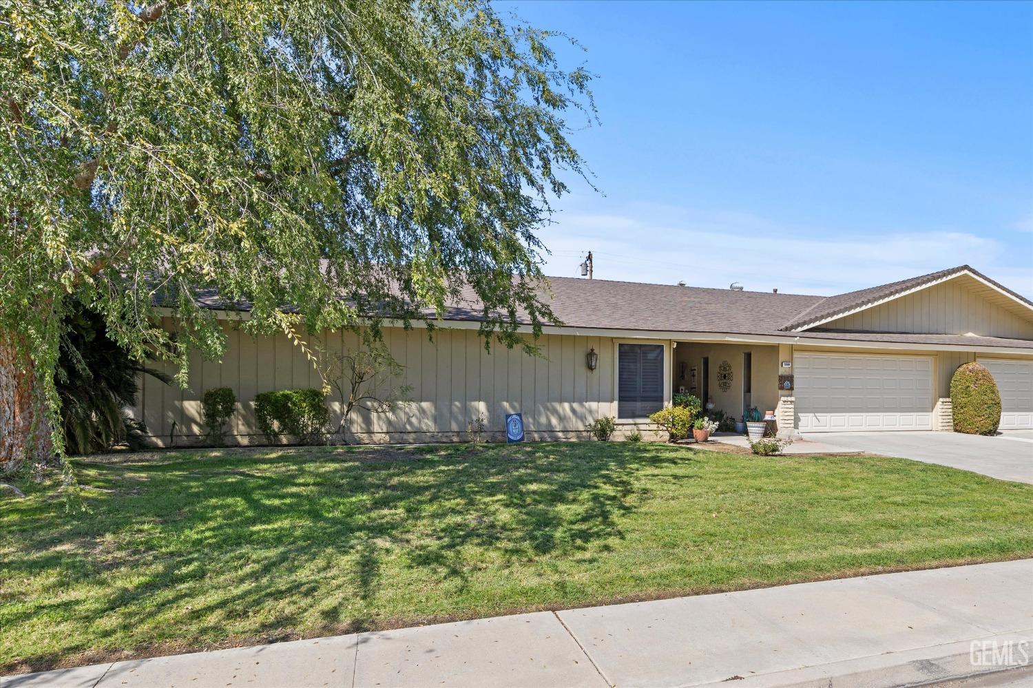 Undisclosed Address Bakersfield, CA 93309 - Photo 2 of 34 a front view of house with yard and trees in the background