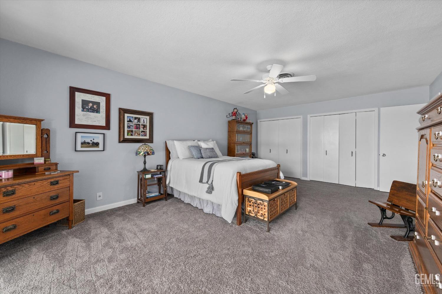 Undisclosed Address Bakersfield, CA 93309 - Photo 22 of 34 a spacious bedroom with a bed and a chandelier