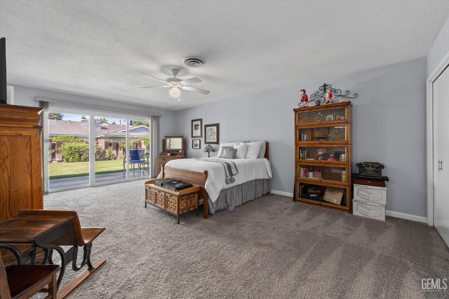 Undisclosed Address Bakersfield, CA 93309 - Photo 23 of 34 a spacious bedroom with a bed a couch and a window