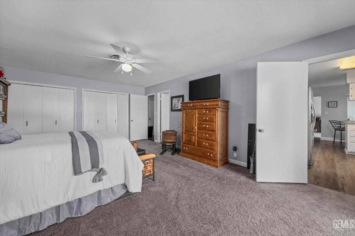 Undisclosed Address Bakersfield, CA 93309 - Photo 24 of 34 a bedroom with furniture and a flat tv screen