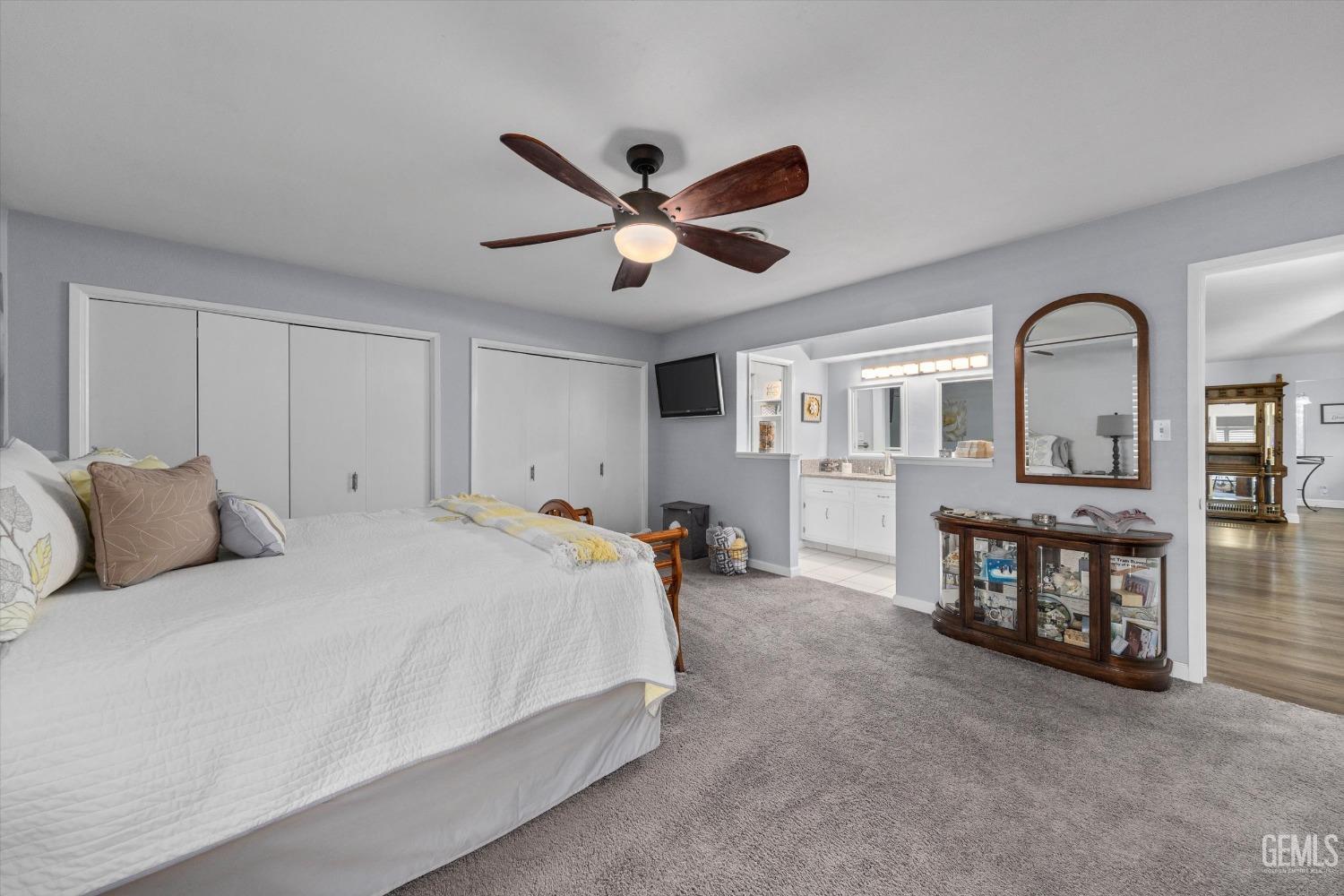 Undisclosed Address Bakersfield, CA 93309 - Photo 27 of 34 a bedroom with a bed and a chandelier