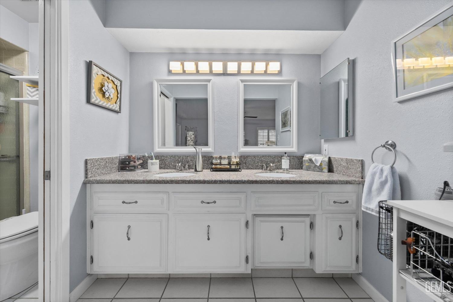 Undisclosed Address Bakersfield, CA 93309 - Photo 28 of 34 a bathroom with double sink and a mirror