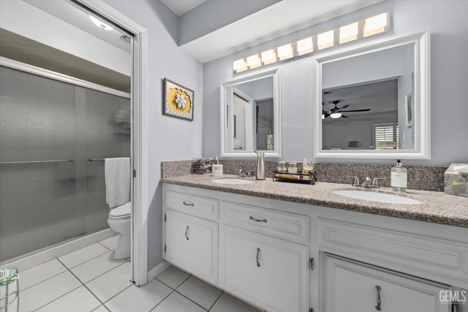 Undisclosed Address Bakersfield, CA 93309 - Photo 29 of 34 a bathroom with a granite countertop sink mirror and toilet