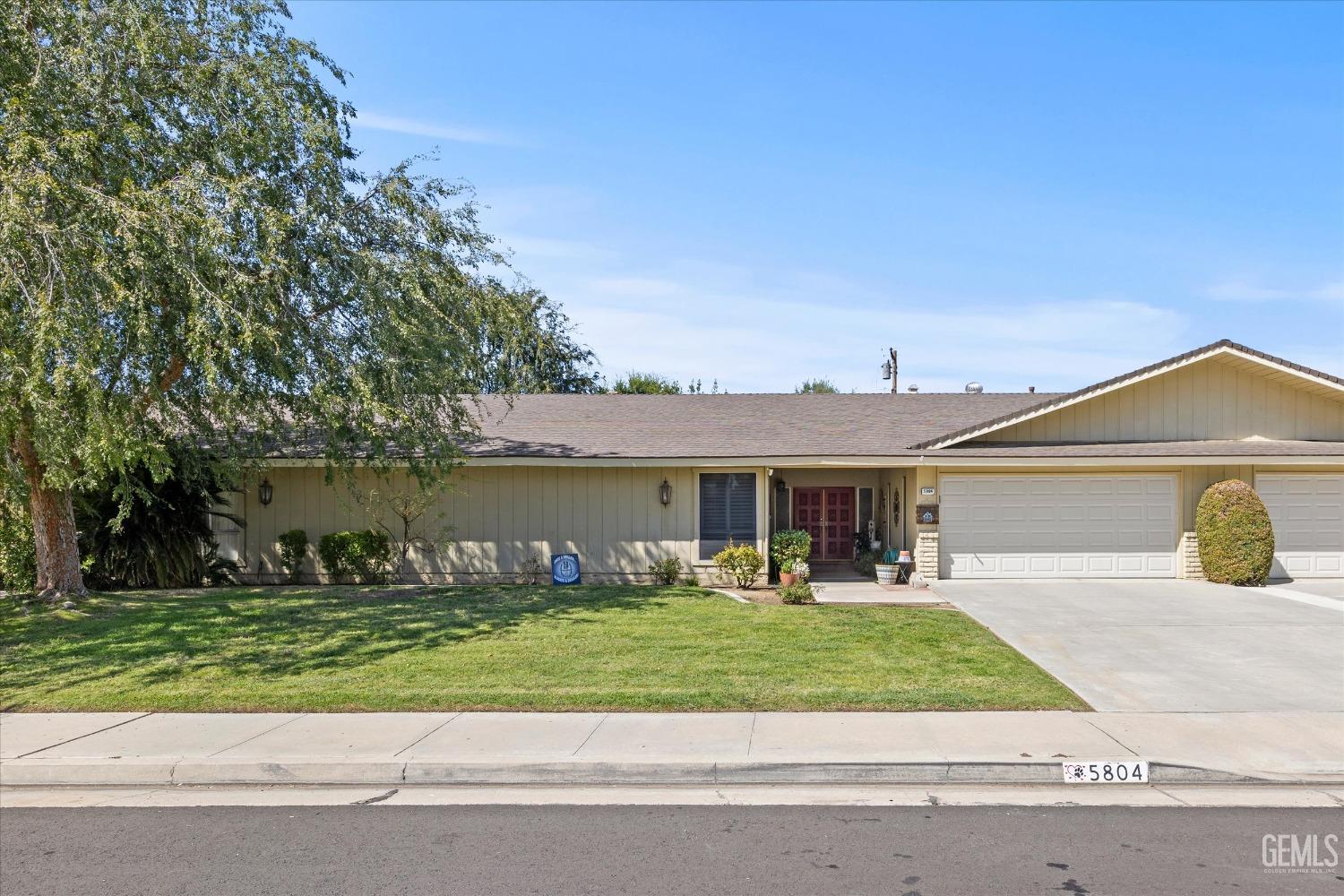 Undisclosed Address Bakersfield, CA 93309 - Photo 3 of 34 a front view of a house with a yard and table and chairs