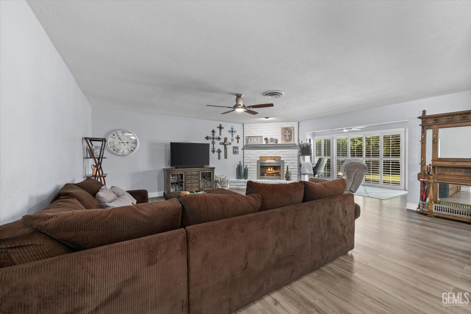 Undisclosed Address Bakersfield, CA 93309 - Photo 8 of 34 a living room with furniture and a flat screen tv