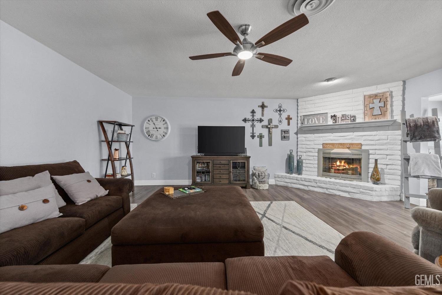 Undisclosed Address Bakersfield, CA 93309 - Photo 9 of 34 a living room with furniture and a flat screen tv